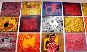 Yayoi Kusama at Tate Mode in front of her artwork.