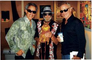 From Santa Monica Mirror- Artist Gary John (center) has gone from living on the streets of Venice to becoming an emerging artist in the past eight months thanks to gallery owners Bruce (left) and Scot Lurie. 